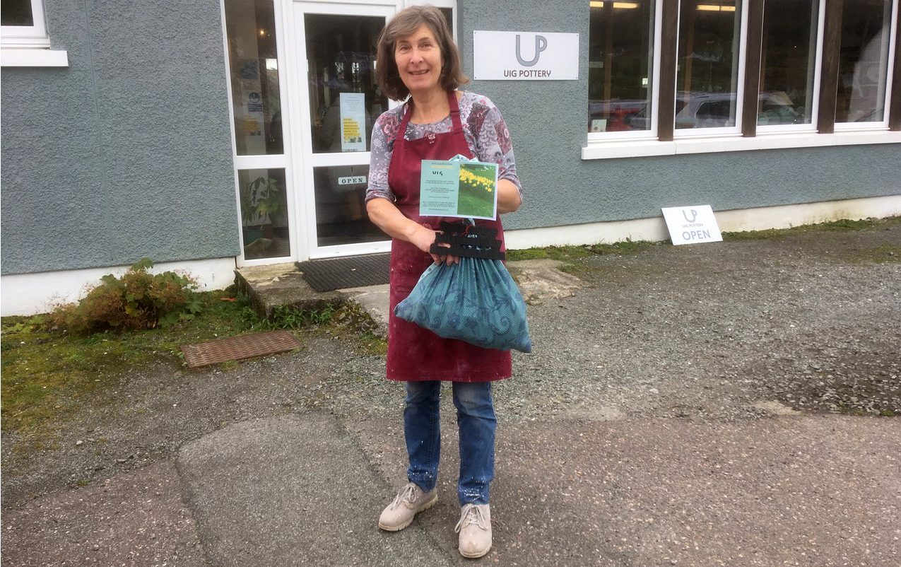 Lady with bag of daffodils at UIg pottery