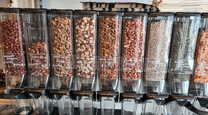 Clear plastic dispensers containing nuts and seeds