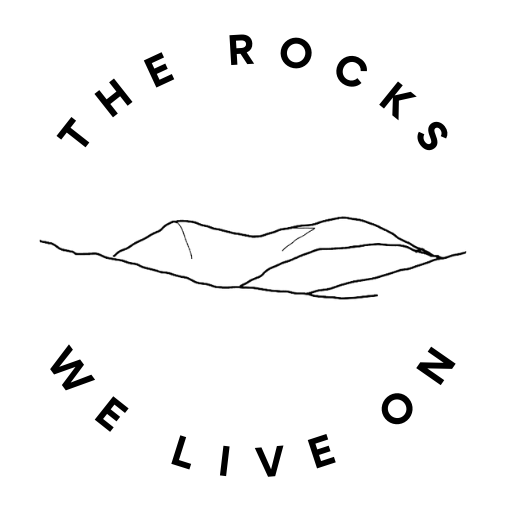 outline drawing of hills encircled by the words 'The rocks we live on'